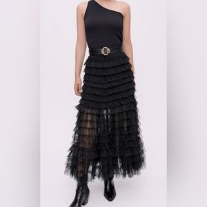 MAJE Long see-through tulle skirt with black dotted Swiss details & flared hem.